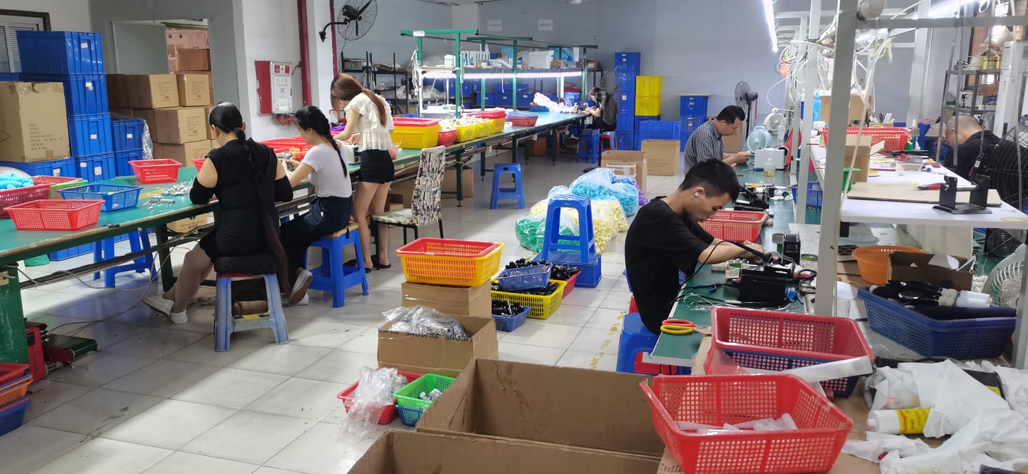 VOVOHO production floor β workers at assembly benches with coloured component bins