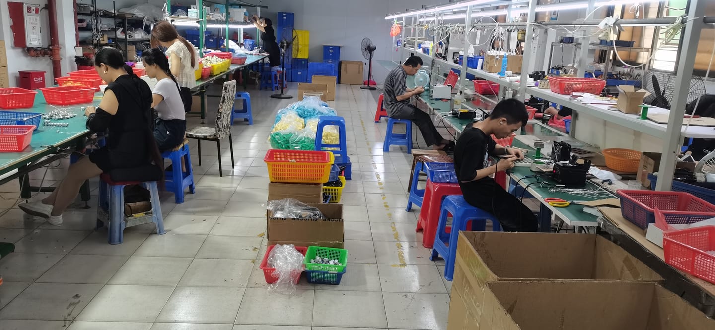 Production floor second angle β assembly workers and material preparation benches