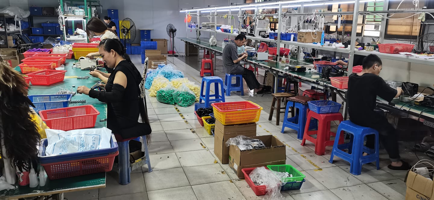 Testing and final assembly station β workers inspecting products at the VOVOHO production line